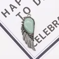 Detail of silver angel wing pendant with teardrop green gemstone on display card - 21x58mm / Green Aventurine