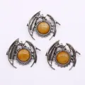 Silver dragon pendant with amber gemstone featuring detailed scales and wings - Topaz