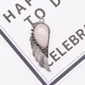 Detail of wing-shaped pendant with pink teardrop stone and silver metallic feathers - 21x58mm / Rose Quartz