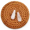 Pair of teardrop-shaped pink quartz beads on a woven mat for DIY jewelry making - White Crystal