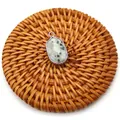 Oval kiwi jasper natural stone pendant with silver plated edge on a woven mat - Azurite