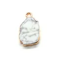 Macro view of natural white marble stone pendant with irregular gold plated edges - Howlite