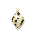 Macro shot of diamond-shaped Dalmatian Jasper pendant with gold-plated edge and ring - Dalmatian Jasper