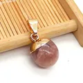 Spherical strawberry quartz pendant with polished gold-plated clasp on a woven bamboo mat - Strawberry Quartz