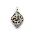 Macro shot of rhombus faceted natural spotted stone pendant with silver metal plating - Dalmatian Jasper