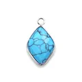 Macro view of a faceted rhombus turquoise pendant with silver-plated metal edges - Blue Turquoise