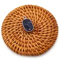 Faceted oval dark blue natural stone pendant with silver plated edge on woven mat - Blue Sodalite