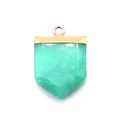 Macro detail of sword-shaped natural green stone pendant with golden metal plating - Green Chalcedony