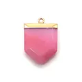Macro detail of hexagonal sword-shaped pink stone pendant with a gold plated loop - Rose Red Chalcedony
