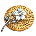 Macro detail of a vintage flower brooch with iridescent shell petals and a white pearl center - Branch With Small Flower Bud Floral Style (No.4)