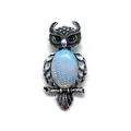 Macro shot of owl brooch with shell inlay and detailed silver feather textures - 29x59mm, 15g / Opal
