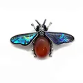 Macro shot of bee brooch featuring red agate abdomen and iridescent abalone shell wings - 41x57mm / Red Agate