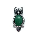 Macro detail of owl-shaped brooch with green stone inlay and fine feather texture - 29x59mm, 15g / Malay Jade