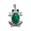 Macro detail of frog pendant featuring green stone and ornate silver carvings - Malachite