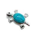 Macro view of turtle pendant featuring a polished silver body and blue turquoise shell - Blue Turquoise