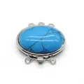 Macro detail of oval turquoise stone inset in a triple-row zinc alloy jewelry clasp - Blue Turquoise