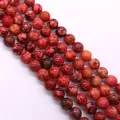 Dettaglio macro di perle tonde in pietra imperiale con venature rosse per gioielli fai da te - N. 6 (Rosso)