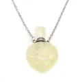 Macro shot of a heart-shaped yellow natural stone essential oil bottle pendant - Citrine