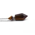 Macro detail of hexagonal tiger eye stone prism pendant with silver metallic connector - Tiger's Eye