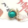 Macro detail of turquoise gemstone bead held by a golden dragon claw jewelry pendant - Turquoise