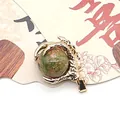 Unakite gemstone ball pendant held by a gold plated dragon claw for DIY jewelry - Unakite