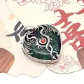 Silver dragon wrap heart pendant with green gemstone and red bead on a white fan - Ruby Zoisite / 32x41mm