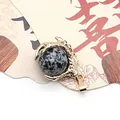 Golden dragon claw pendant featuring a snowflake obsidian natural stone bead - Snowflake Obsidian