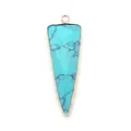 Macro shot of triangular turquoise pendant with gold plated edges and veined texture - Blue Turquoise