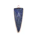 Macro shot of triangular lapis lazuli pendant with gold plating and V-shaped engraving - Lapis Lazuli