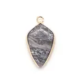 Macro detail of natural stone shield pendant with golden metal border for DIY jewelry - Map Stone