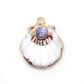 Detailed view of scallop shell pendant with blue natural stone and gold metal frame - Blue Spot Stone