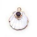 Macro detail of fan-shaped white mother of pearl pendant with gold plating and purple gemstone - Purple Crystal