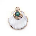 Macro view of shell pendant with gold plating and turquoise stone detail - Ruby Zoisite