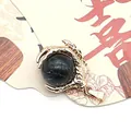 Golden dragon claw pendant holding a round black marble natural stone bead - Black Line Howlite