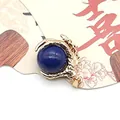 Golden dragon claw pendant featuring a deep blue round gemstone with mystic oriental style - Lapis Lazuli