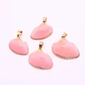 Detailed view of four pink dyed natural shell charms with gold plated edges and jump rings - Pink