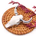 Detail of silver-plated bull head skull pendant resting on a woven rattan mat with flowers - White Bone Texture Silver Horn Style (No. 1)