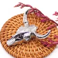 Macro view of a silver bull skull pendant with detailed bone texture and hanging ring - Full Metal Bright Silver Retro Style (No. 2)
