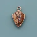 Detailed view of natural spotted stone shield pendant with rose gold plated metal edge - Shield Shape Pendant (1003-T250705018) / Jasper