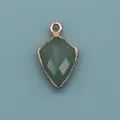 Macro detail of a shield-shaped green natural stone pendant with gold plated edges - Shield Shape Pendant (1003-T250705018) / Green Aventurine