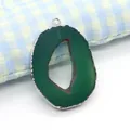 Close-up of green natural agate geode pendant with silver plating and irregular oval shape - Green