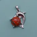 Detail of silver dolphin pendant with natural red stone bead and polished finish - Sesame Jasper