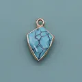 Macro detail of faceted blue stone pendant with gold edge and shield shape design - Shield Shape Pendant (1003-T250705018) / Blue Turquoise