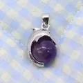 Macro detail of dolphin pendant with silver metal and round purple amethyst stone - 14x23mm / Purple Crystal