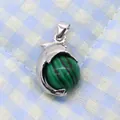 Macro detail of silver dolphin pendant holding a green striped malachite style bead - 14x23mm / Malachite