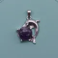 Silver dolphin pendant with round purple amethyst gemstone on a light blue tray - Purple Crystal