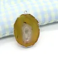 Natural agate geode slice pendant with silver-plated rim and white crystal core - Amber Yellow