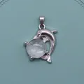Silver dolphin pendant featuring a light blue translucent natural stone gemstone - White Crystal