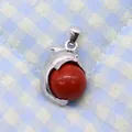 Silver dolphin pendant with a dark red gemstone bead on blue checkered fabric - 14x23mm / Red Jasper