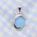 Silver dolphin pendant featuring a light blue opal bead on a blue checkered background - 14x23mm / Opal
